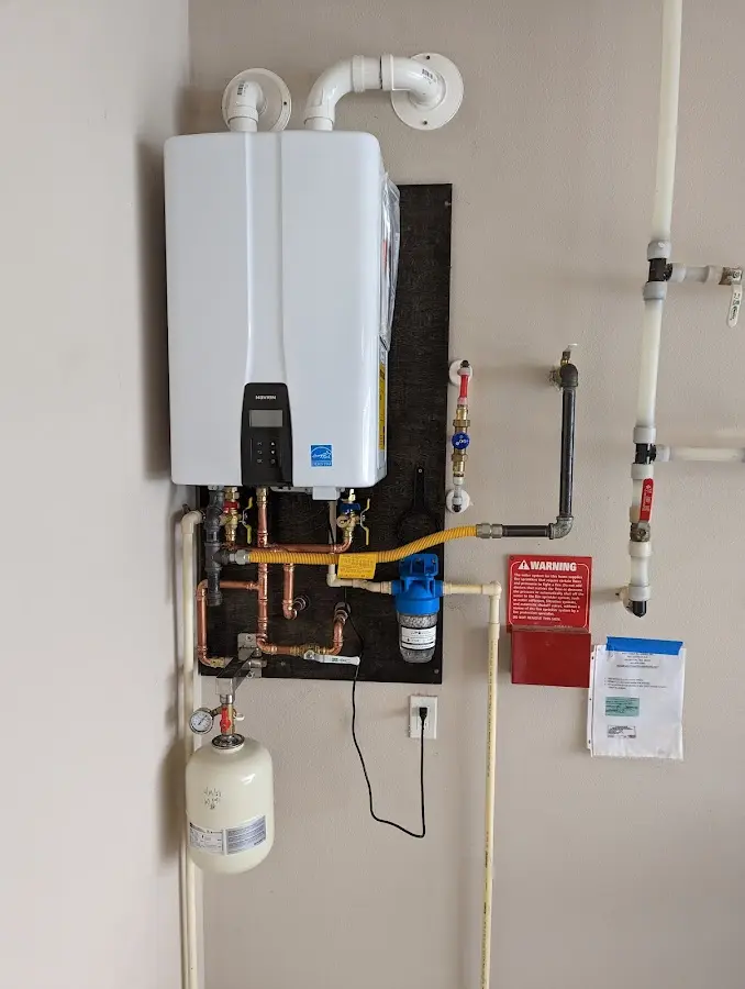 Professional plumber installing copper piping in a Beaufort home